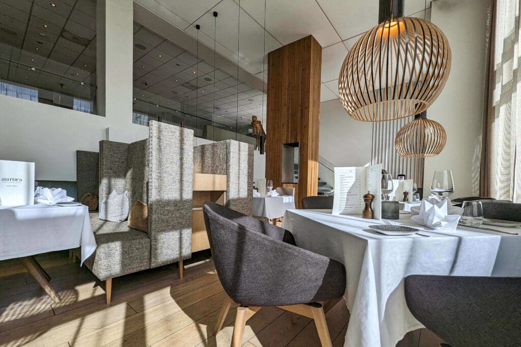 Prestine white table clothes and upscale interior of the Aurora Iceland restaurant