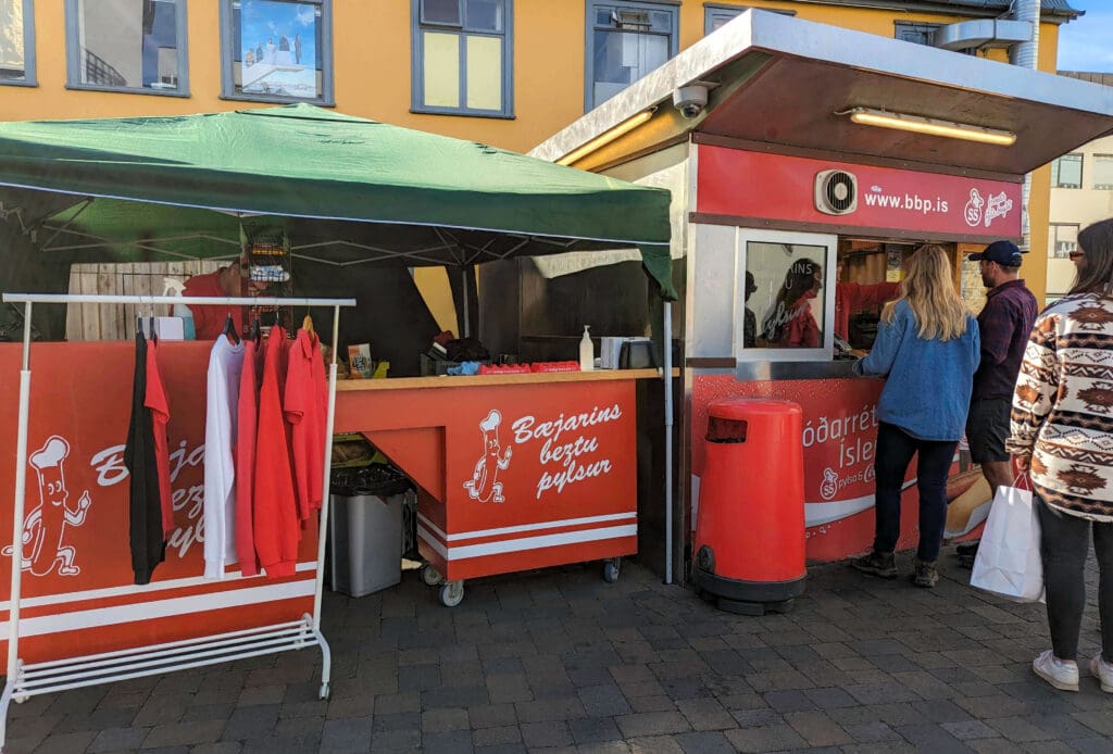 People waiting in line for a hotdog at Bæjarins Beztu Pylsur hotdog stand in downtown Reykjavik