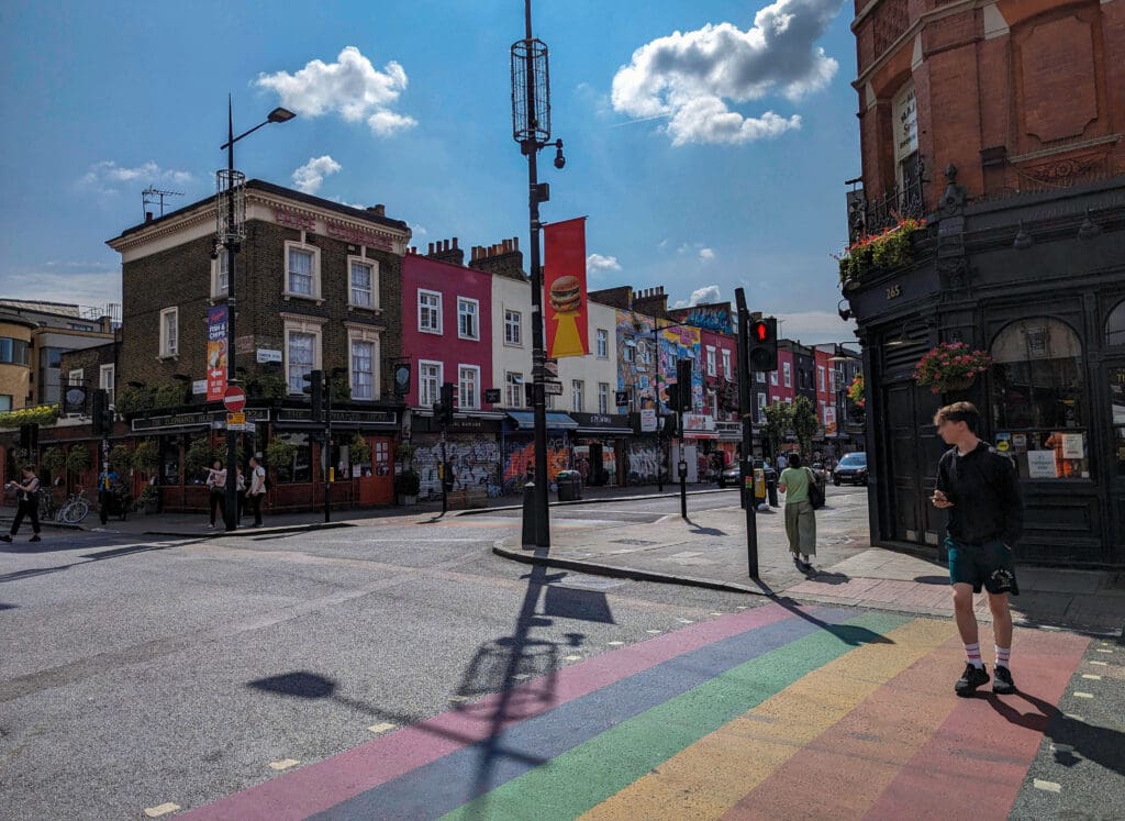 A rainbow crosswalk adds to the colorful shops of the Camden Market