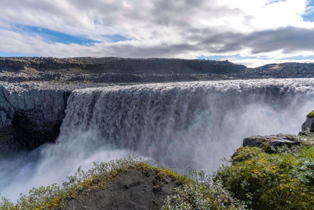 Enormous raging waters of the Detifoss waterfall the most powerful waterfall in Europe surrounded by volcanic rock