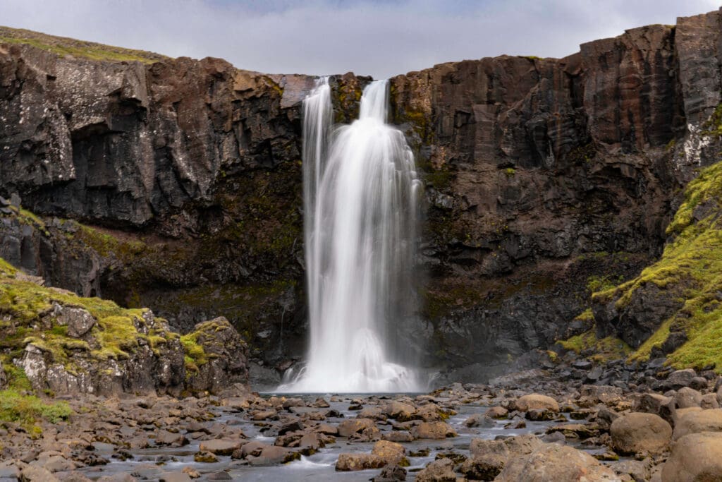 The showering waters of the Gufufoss waterfall raining down on to the rocks below