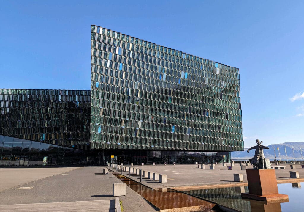 Glass panels of the Harpa Concert Hall sine in the sunlight in downtown Reykjavik