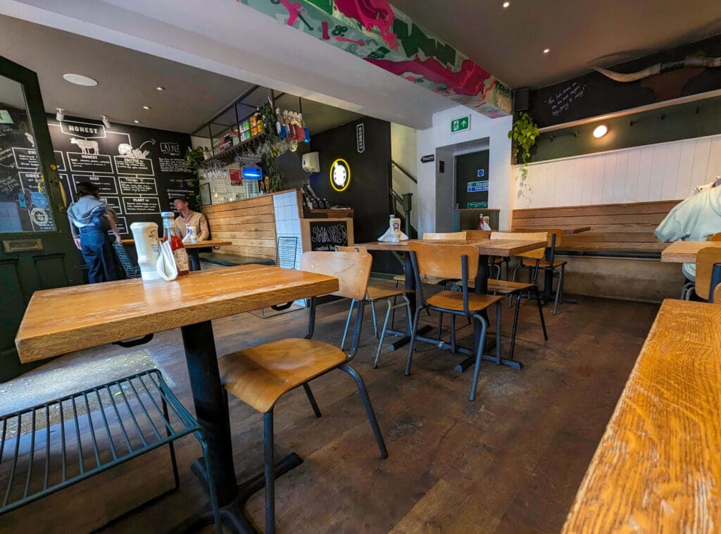 Open tables and a bar like atmosphere make up the interior of Honest Burger