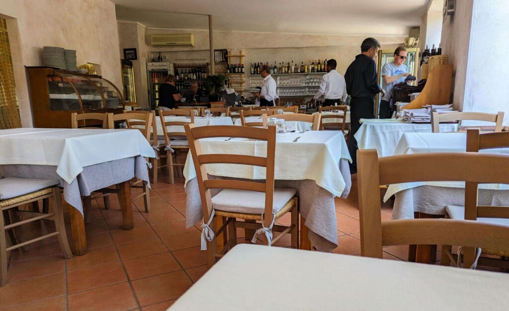 Multiple clean open tables inside the unassuming interior of the Lo Sfizio restaurant found on Capri