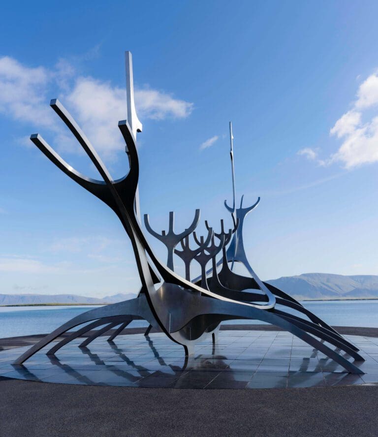 The blue sunny sky glistens off of the metal Sun Voyager Sculpture in Reykjavik