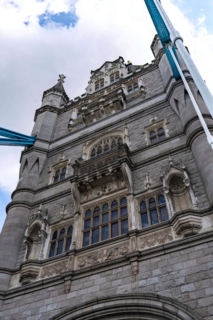 Looking up at the century old stone and decedent windows of the Tower Bridge in London