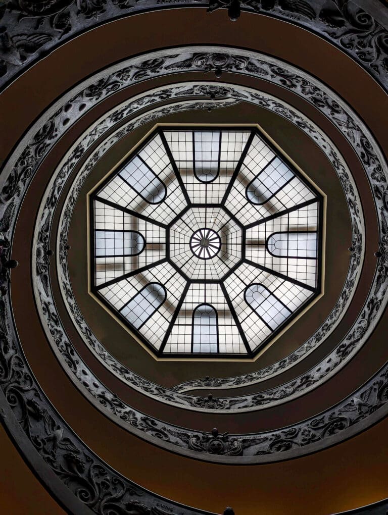 A decadently designed spiral staircase winds up to the octagon skylight inside the Vatican