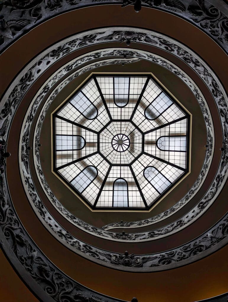 A decadently designed spiral staircase winds up to the octagon skylight inside the Vatican