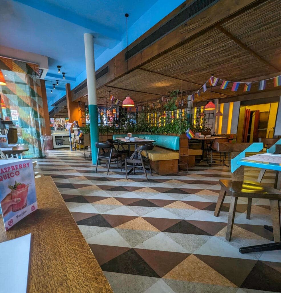 Colorful and patterned floor and walls make up the chairs and booths of Wahaca