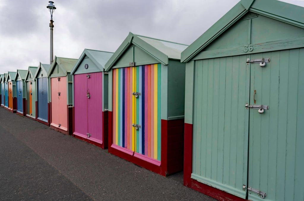 Centuries old beach huts painted different vibrant colors lining the beach