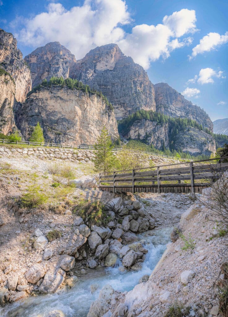 The gorgeous Col de Locia trail with a small bridge over a river creates one of the best hikes in the Dolomites