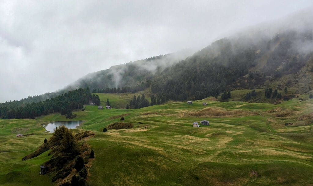 Open green fields atop the Seceda hike in the Italian Dolomites