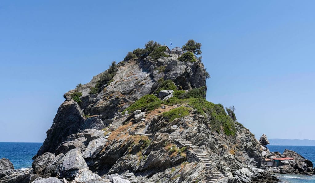 The Agios Ioannis Kastri church sits atop a cliff overlooking the ocean.