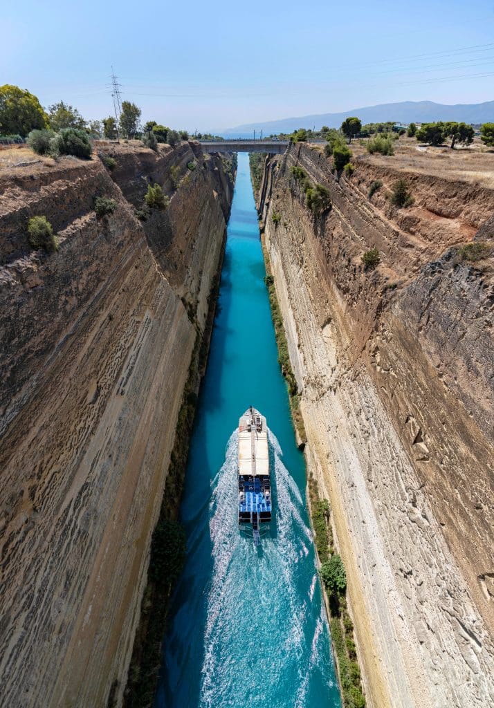 A boat makes its way through the narrow Corinth Canal.