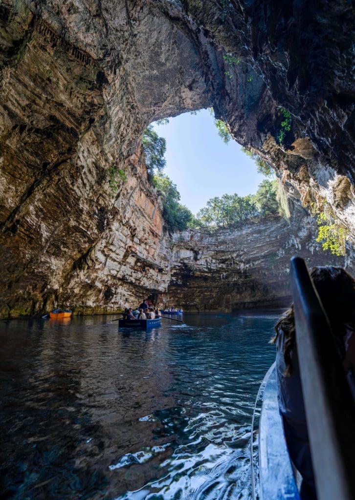 Floating through the large open topped Melissani cave in Kefalonia Greece, one of the best things to do in Greece.