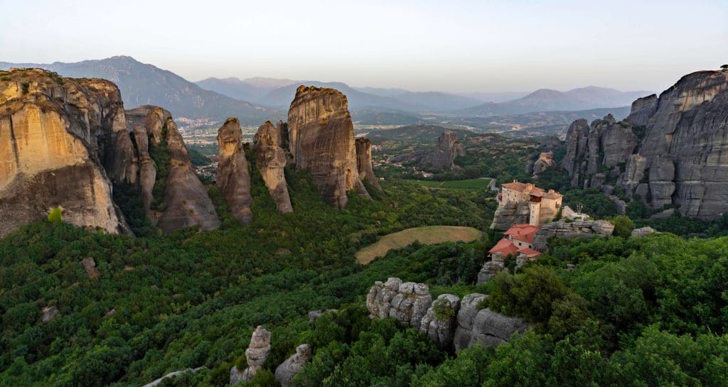 Watching the sunrise over the pillars and monasteries of Meteora is one of the best things to do in Greece.