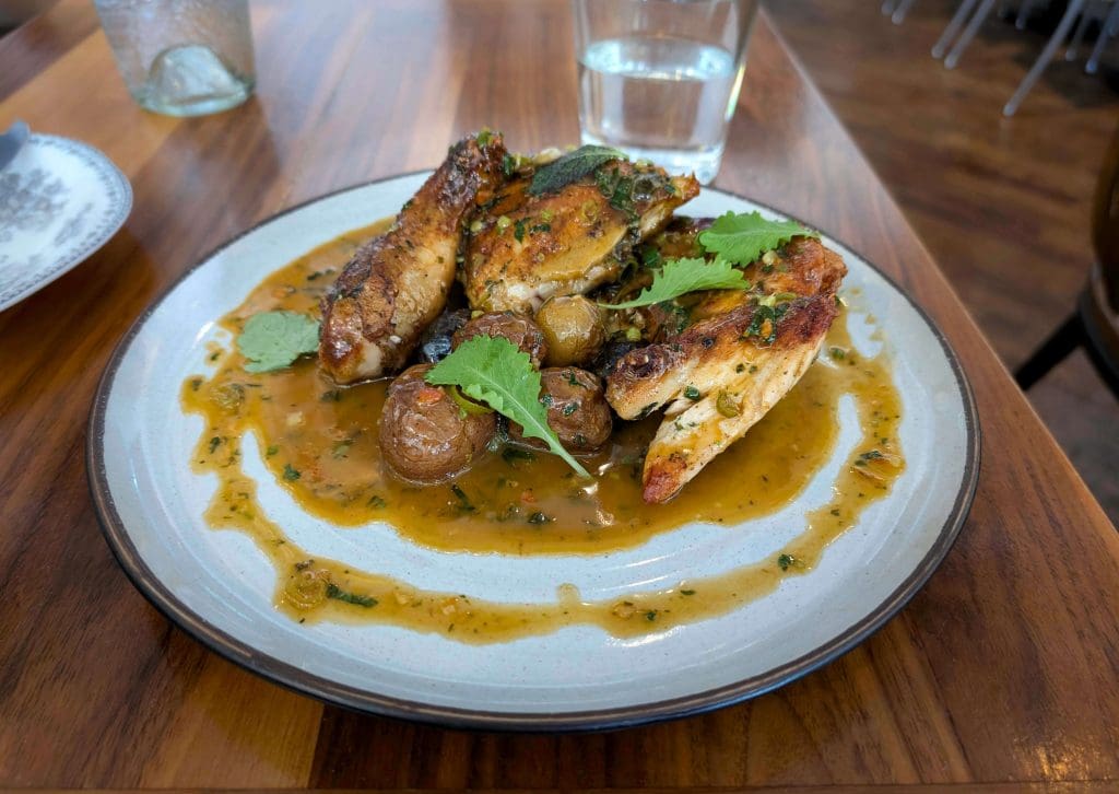 A finely seasoned and prepared crispy half chicken at Virtue, one of the best restaurants in Chicago.