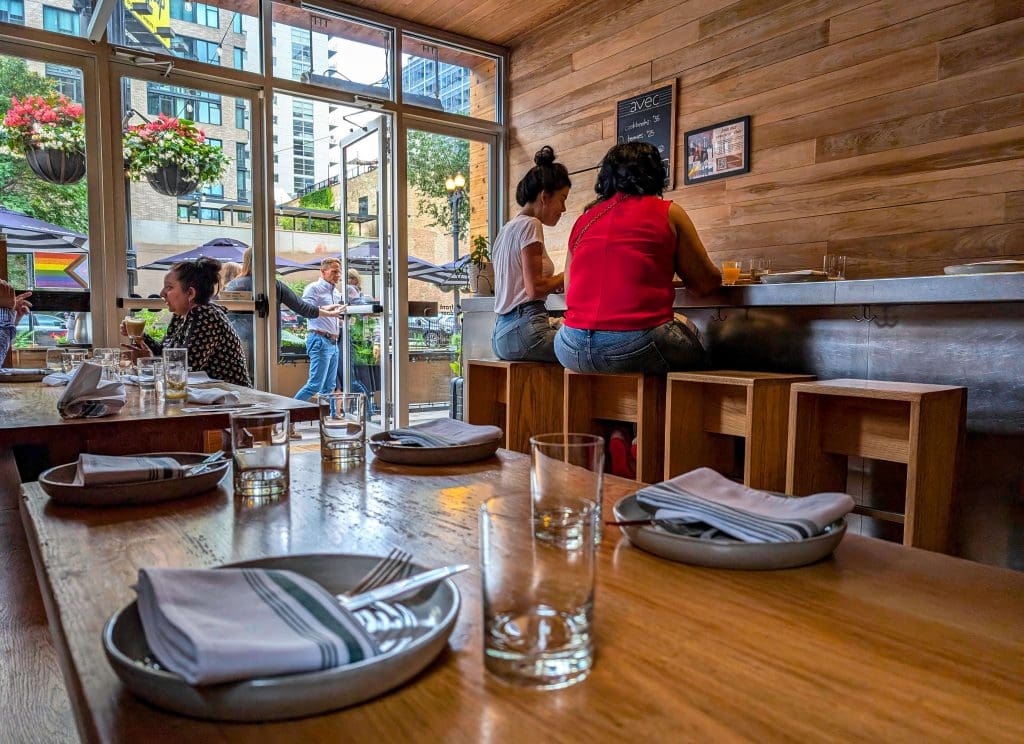 Wood walls, tables, and chairs make up the inviting interior of Avec, the best Mediterranean restaurant in Chicago.