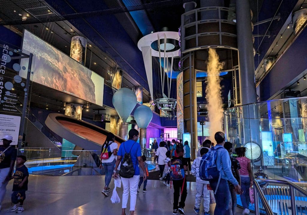 Large flashy exhibits and interactions of the storms section inside the massive Museum of Science and Industry.