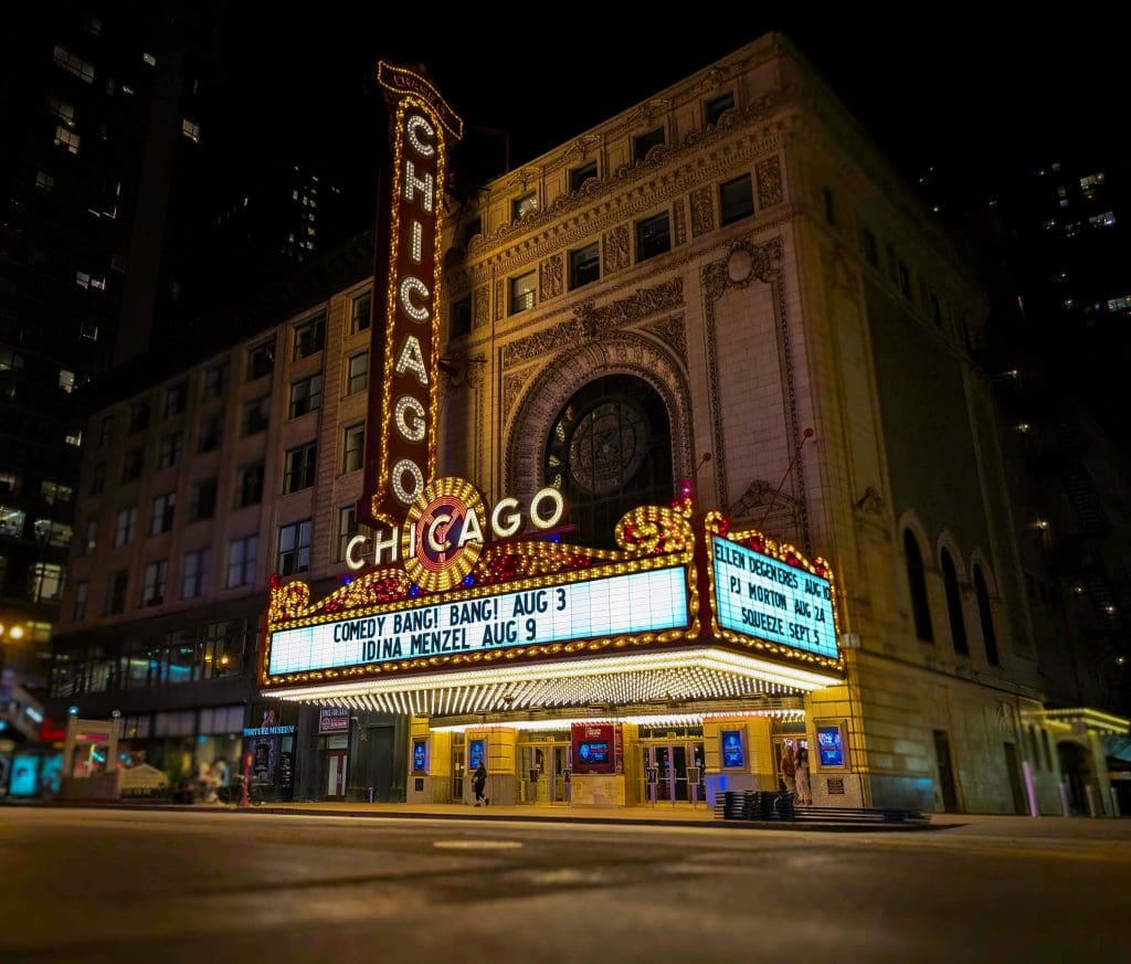 Flashing lights of the Chicago Theatre sign marquee during the night in downtown Chicago, one of the best photo spots in Chicago.