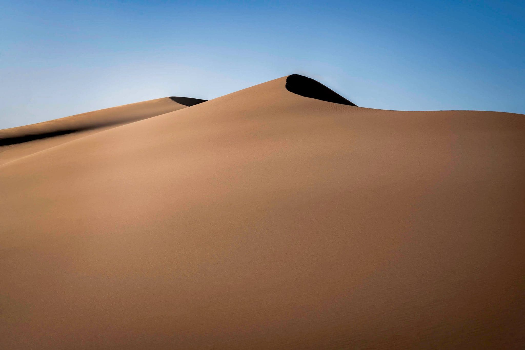 Silky smooth with a pinkish hue sand dunes paint a picture of calm as one of the best parks in Utah