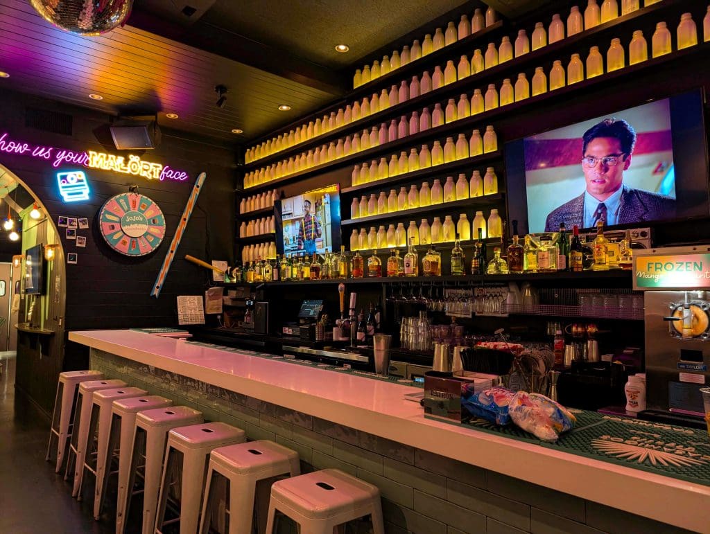 The luminescent bar and wall of drinks at JoJo's Shake Bar in downtown Chicago.