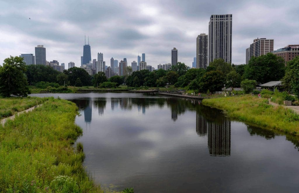 The city skyline reflecting off the South Pond in Lincoln Park, a great Chicago instagram spot.