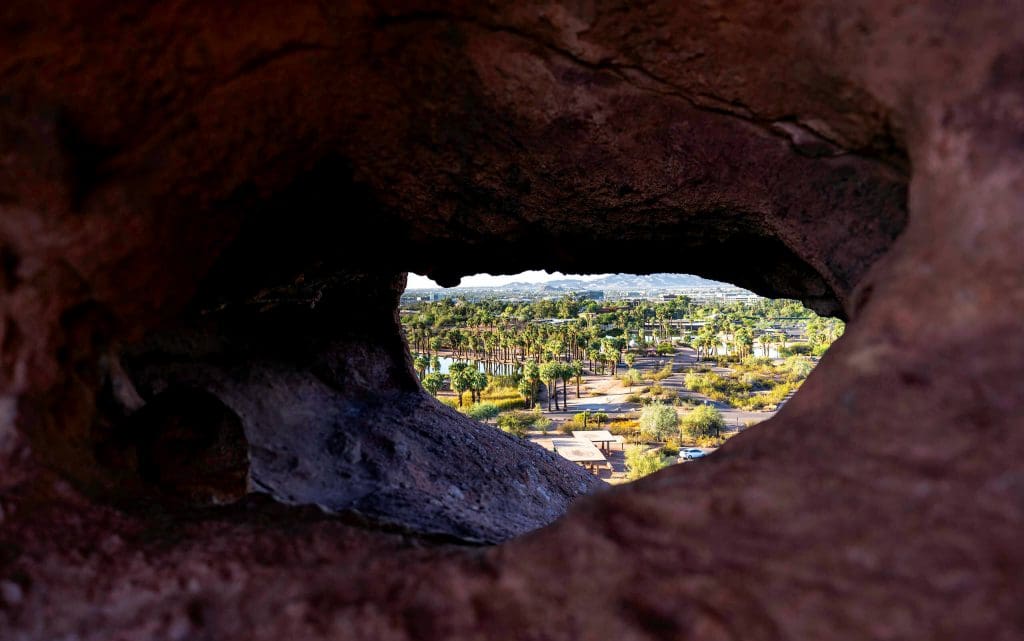 Looking through the hole to see palm trees and ponds in the Hole in the Rock photos