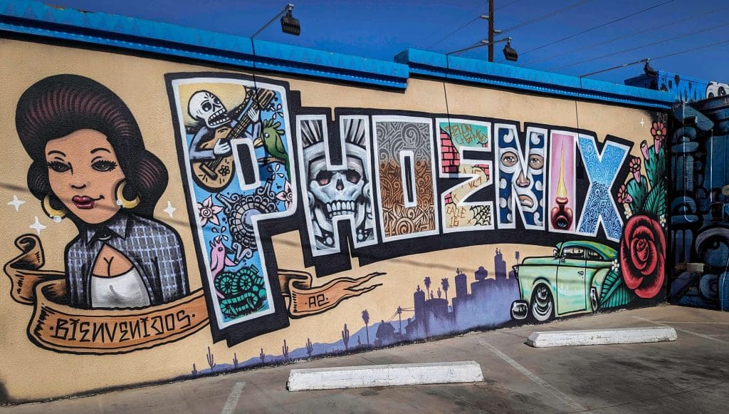 Different Latin designs make up the expressive city art mural behind Barrio Cafe.