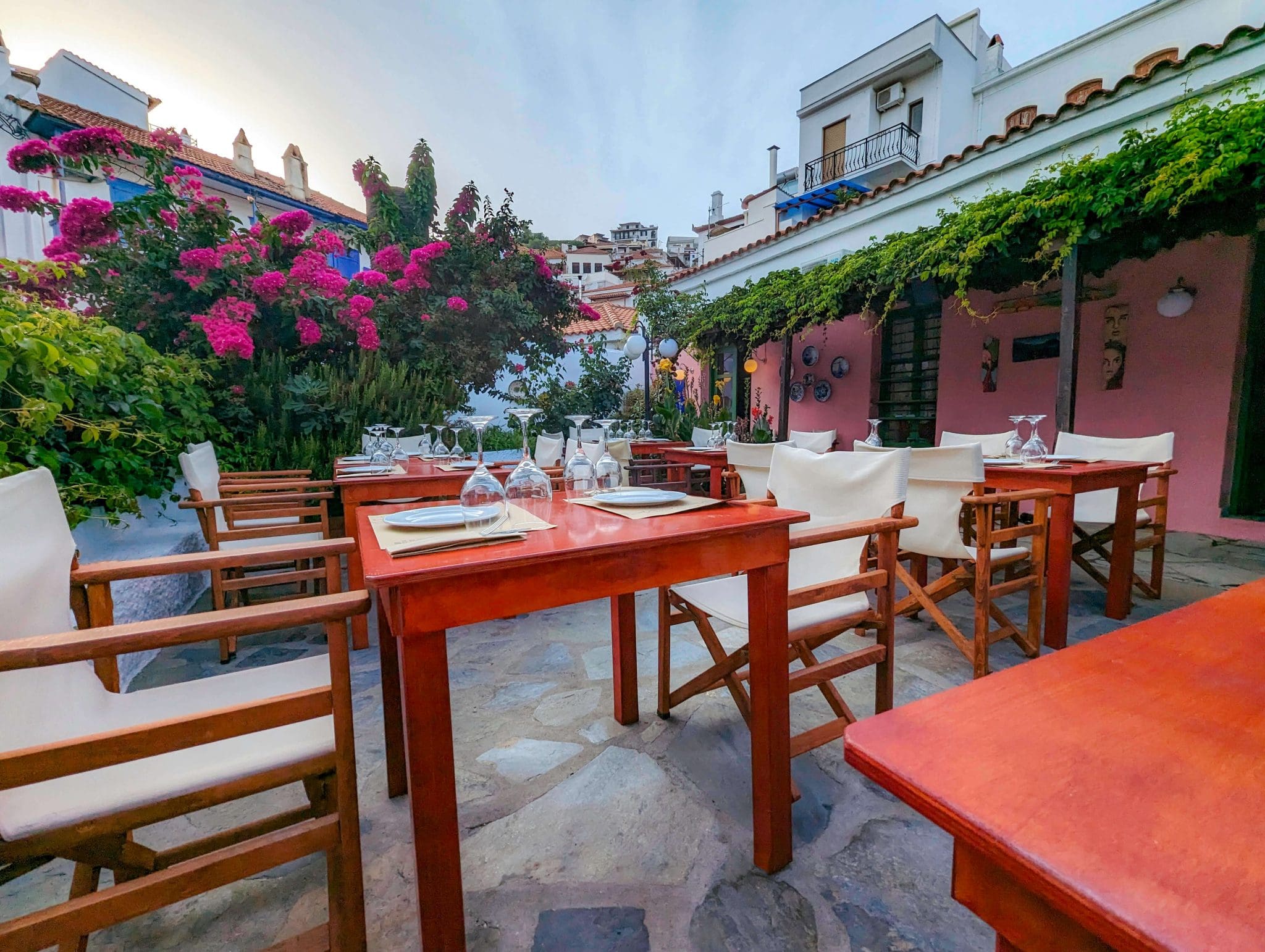 Vibrant flowers and plants make up the patio of Anna's Restaurant, one of the most beautiful and best restaurants in Greece.