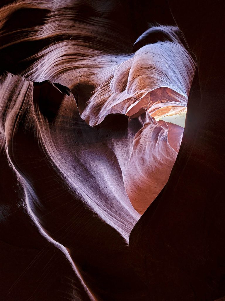 Looking up at the heart shaped wavy walls of Antelope Canyon, one of the most unique things to do in Arizona.