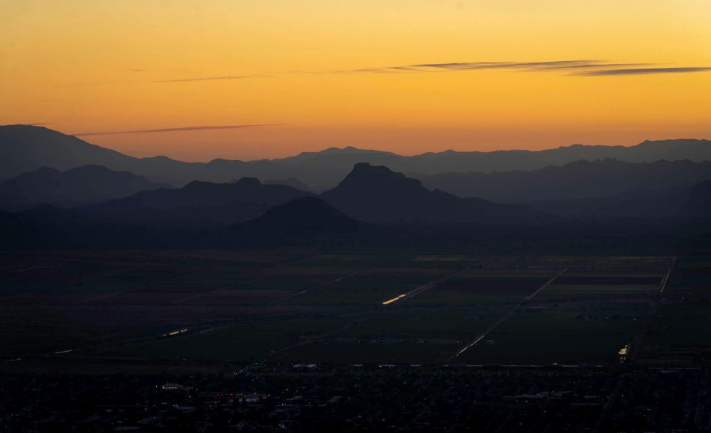 Watching the warm sky sights of the sunrise from stop Camelback Mountain a top hike in Arizona.