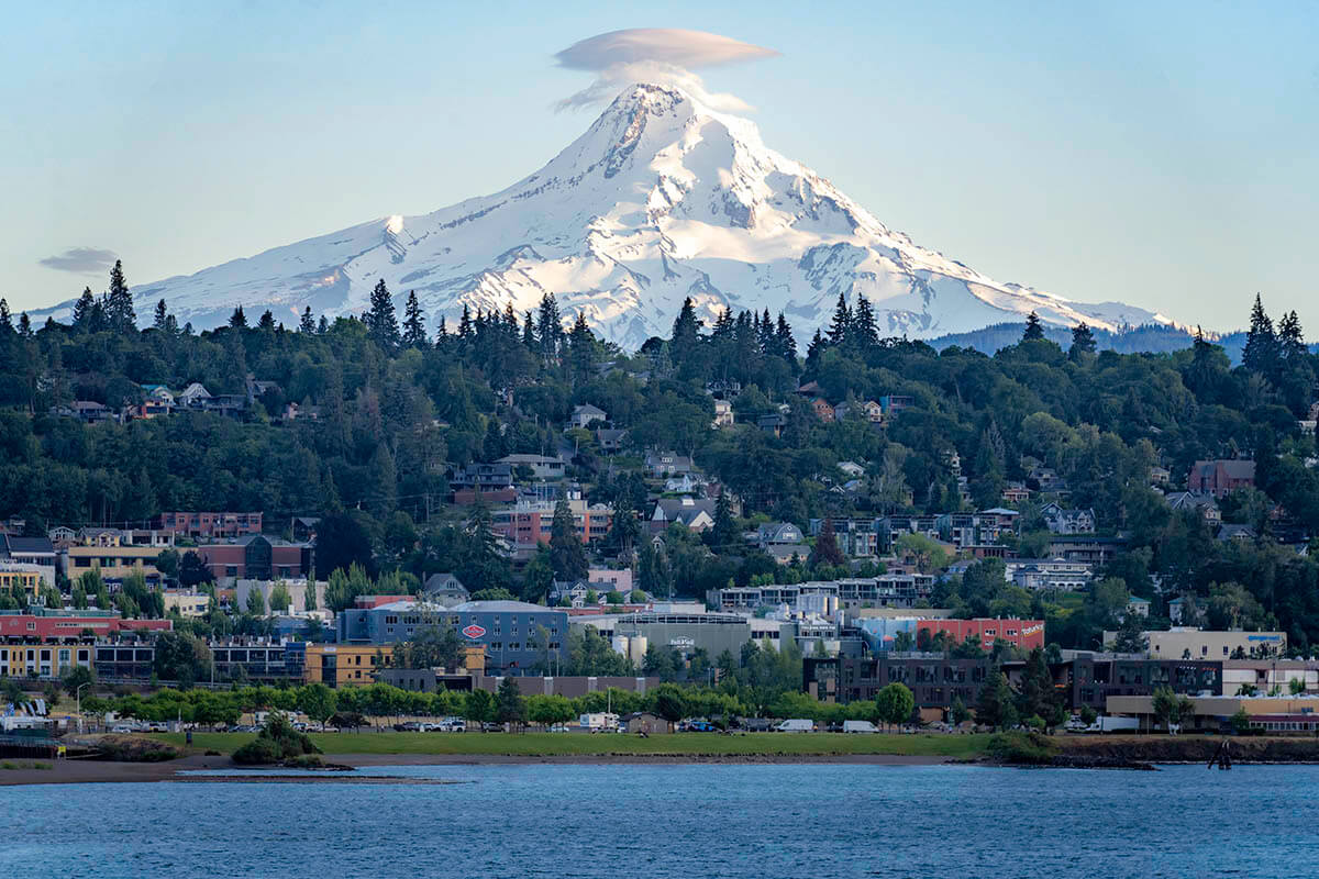 Looking on to a small town on the water while the massive Mt. Hood looms in the background at one of the best Oregon photography spots in the state.