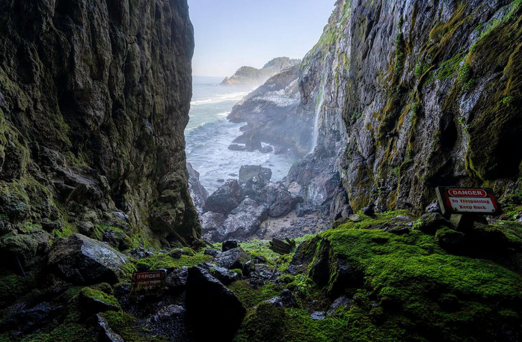 Watching the waves crash against the rocks while inside the massive moss covered Sea Lion Cave, a can't miss Oregon photography location.