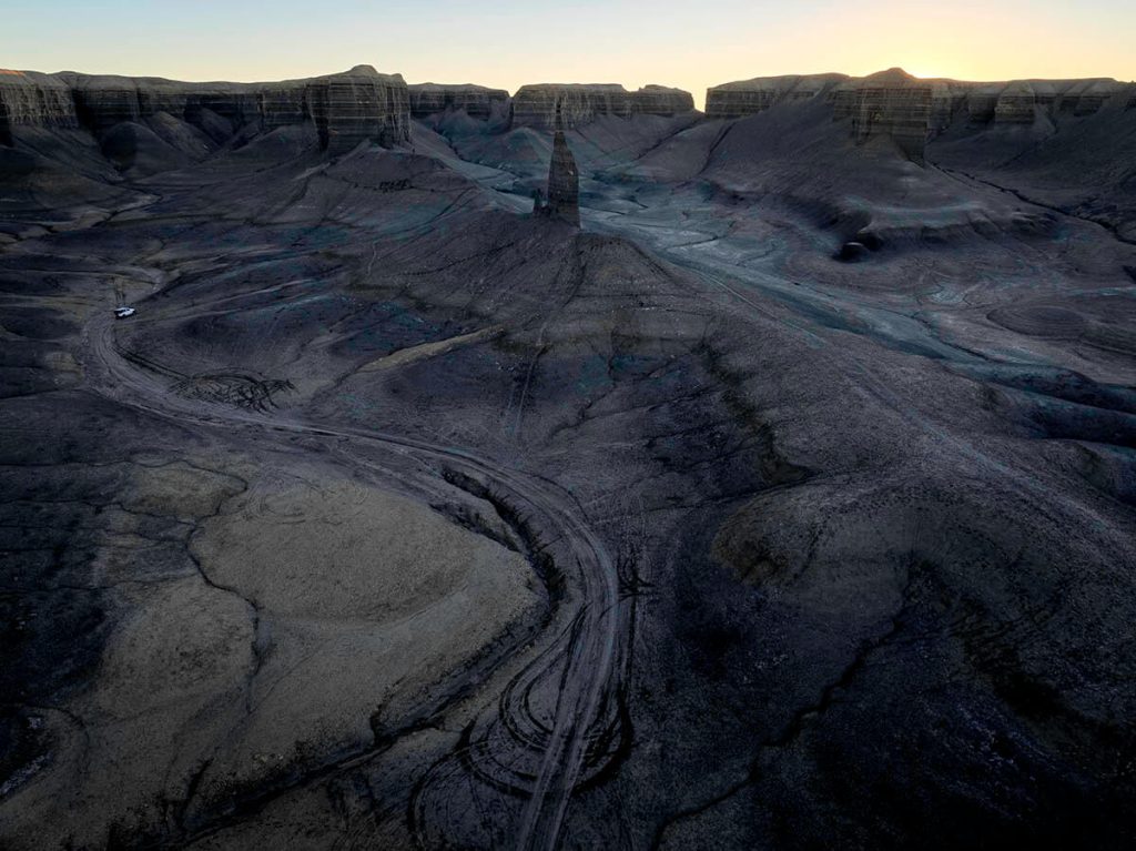 A secluded landscape in Utah of stark otherworldly terrain with the Silver Spire rising from the ground.