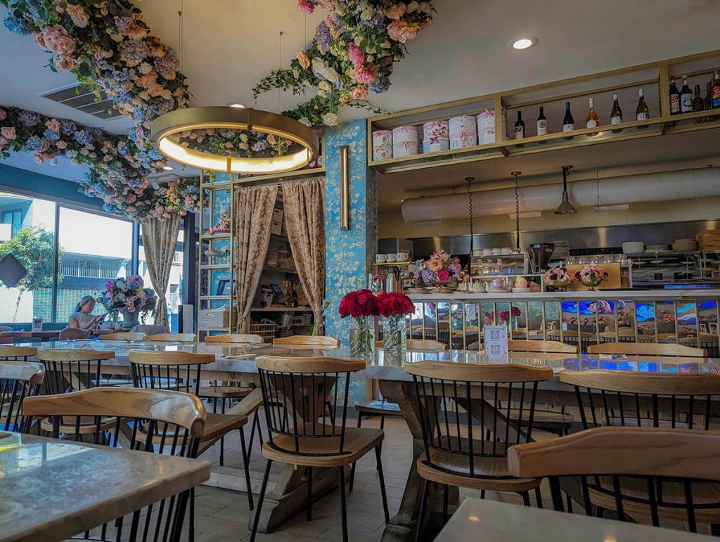 Bright flowers and a vibrant design make up the interior of Son and Garden, a great place for the best food in San Francisco.