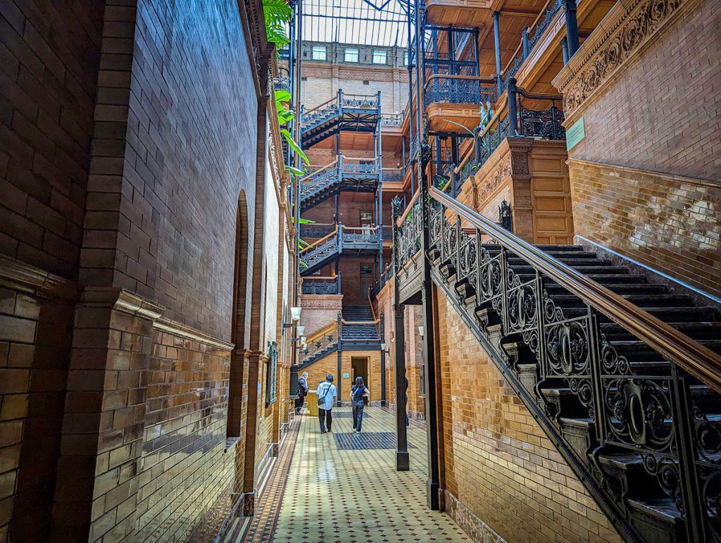 19th century stairs leadup to the large glass roof of the Bradbury Building, a stunning movie location in Los Angeles.