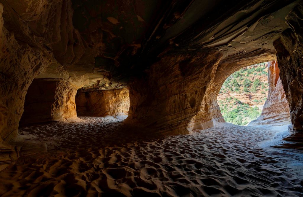 Inside the smooth walls and soft sand of the Kanab Sand Caves.