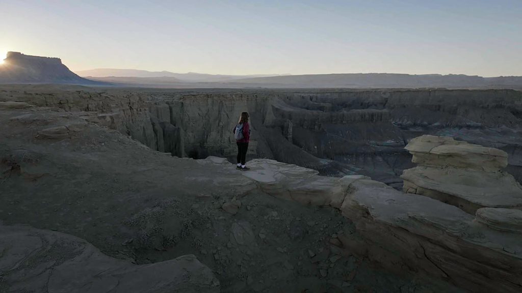 Looking out from the Moonscape Overlook as the sun sets over the expansive and barren badlands.