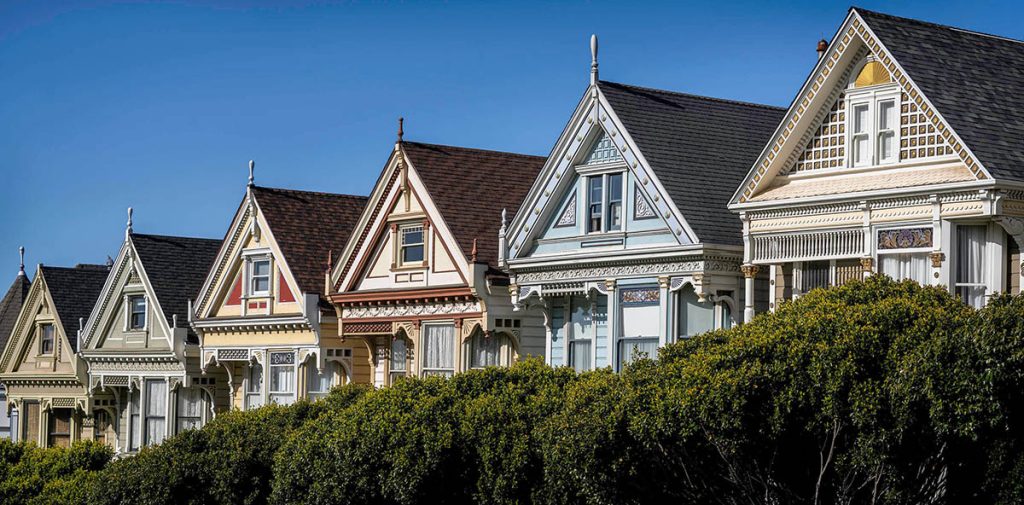 A row of pristinely painted houses all different colors and all perfect, known as the painted Ladies.