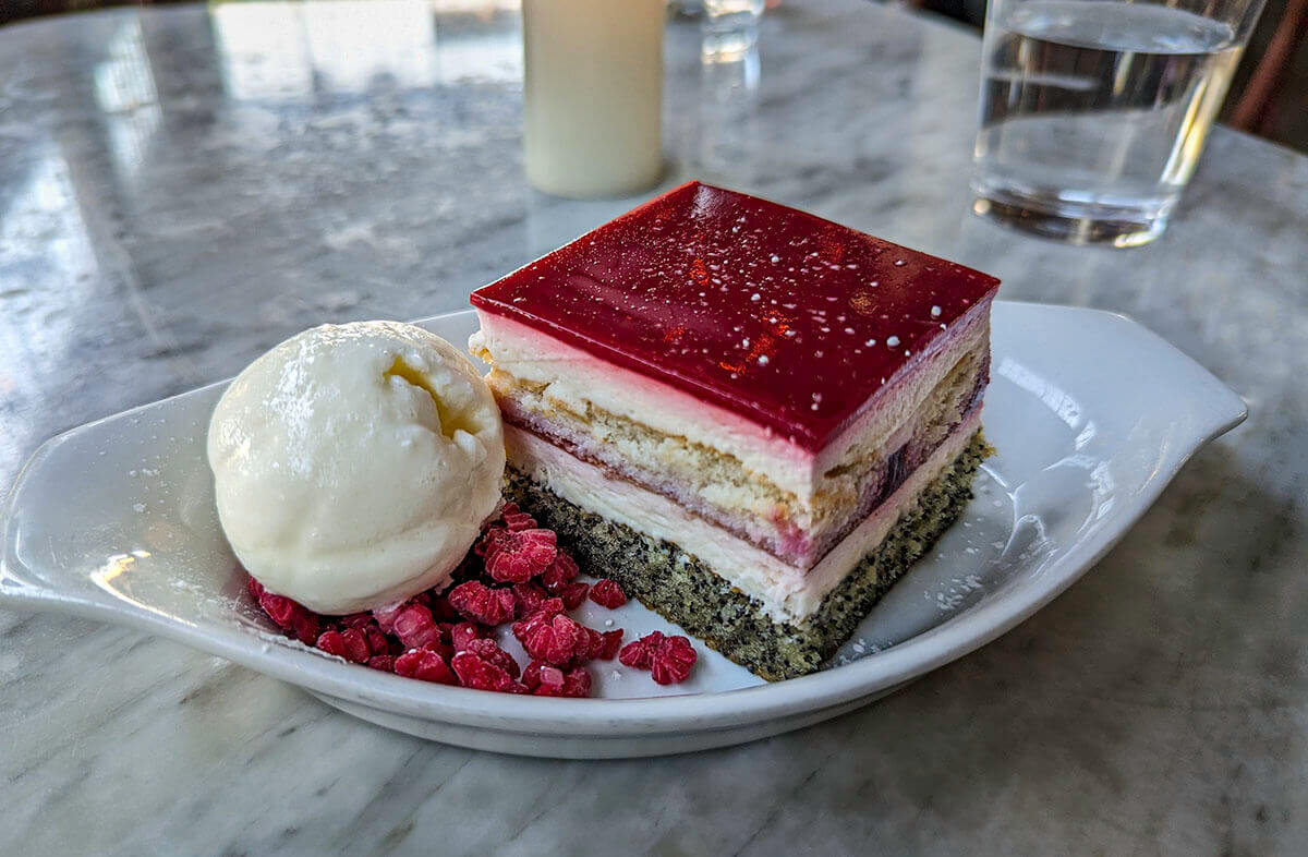 Layer upon layer of soft cake, rich, cream, and cool raspberries with a scoop of vanilla ice cream at Rossoblu.