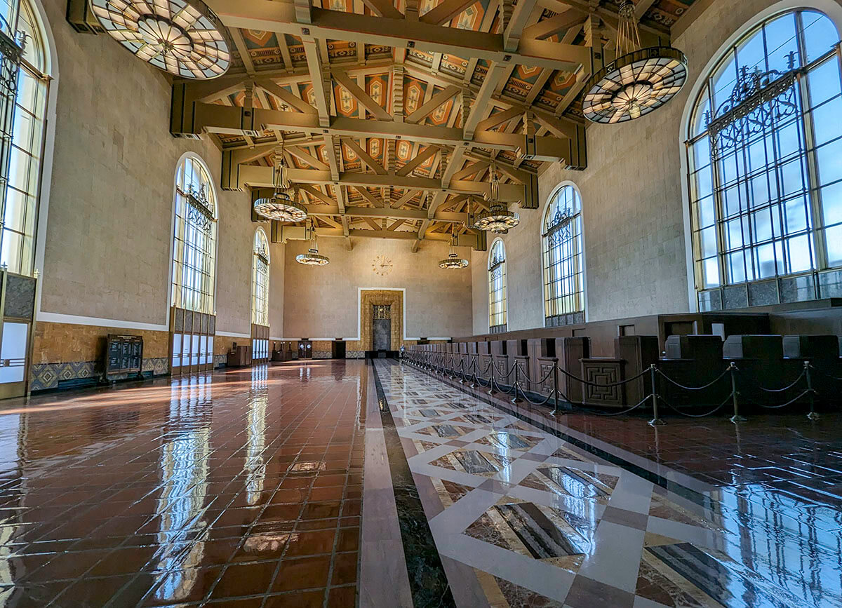 The gorgeous open wing of the Union Station in Los Angeles with its decorative ceiling and spotless floors.